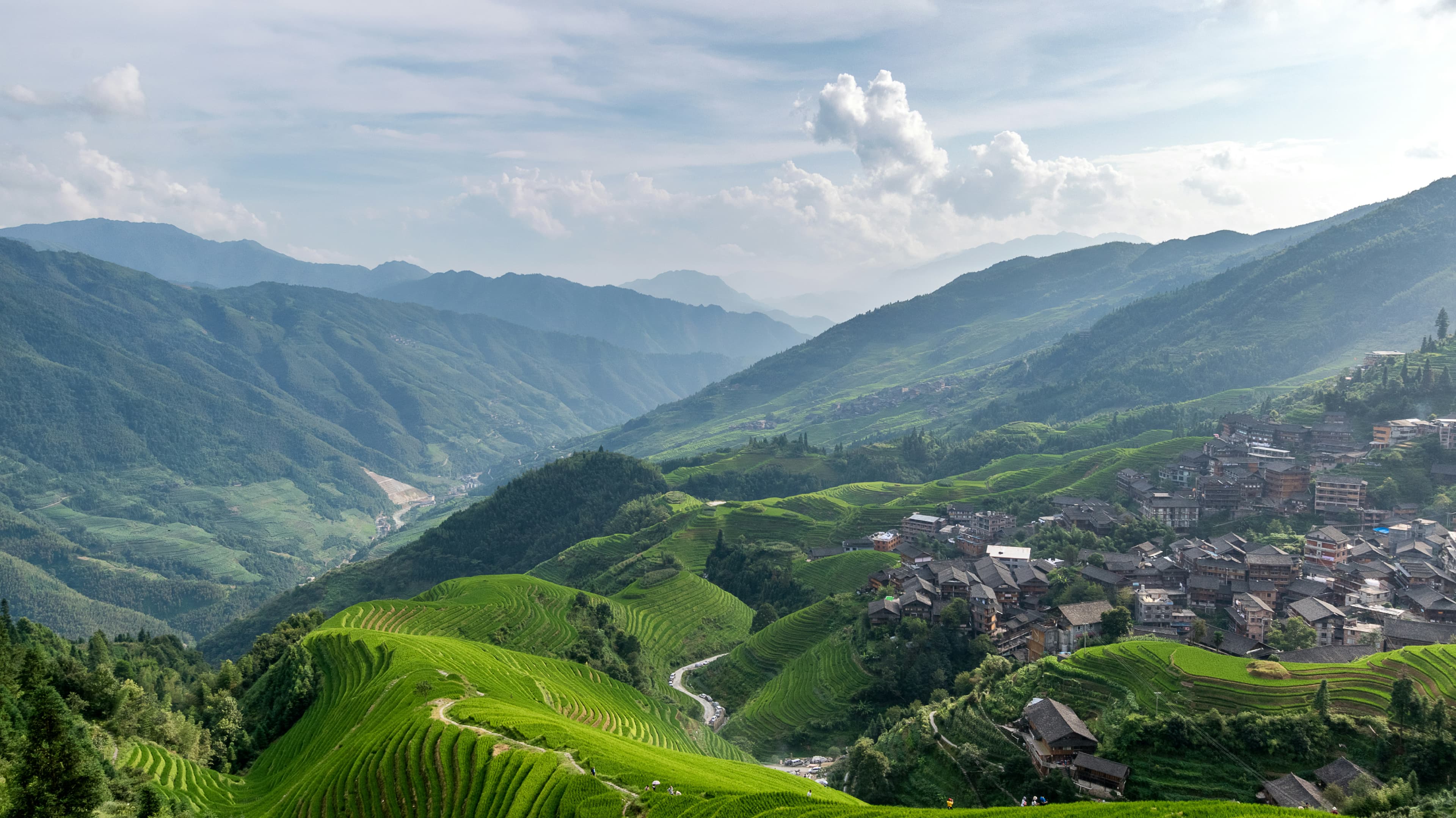 Longji Rice Terraces in Guilin — a village sits among terraced fields and karst peaks