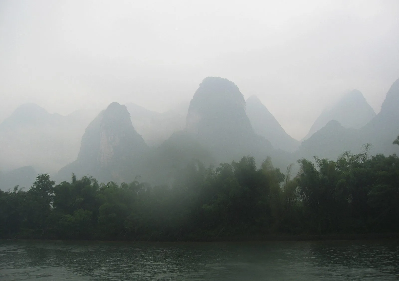 Longji Rice Terraces in Guilin — a village sits among terraced fields and karst peaks